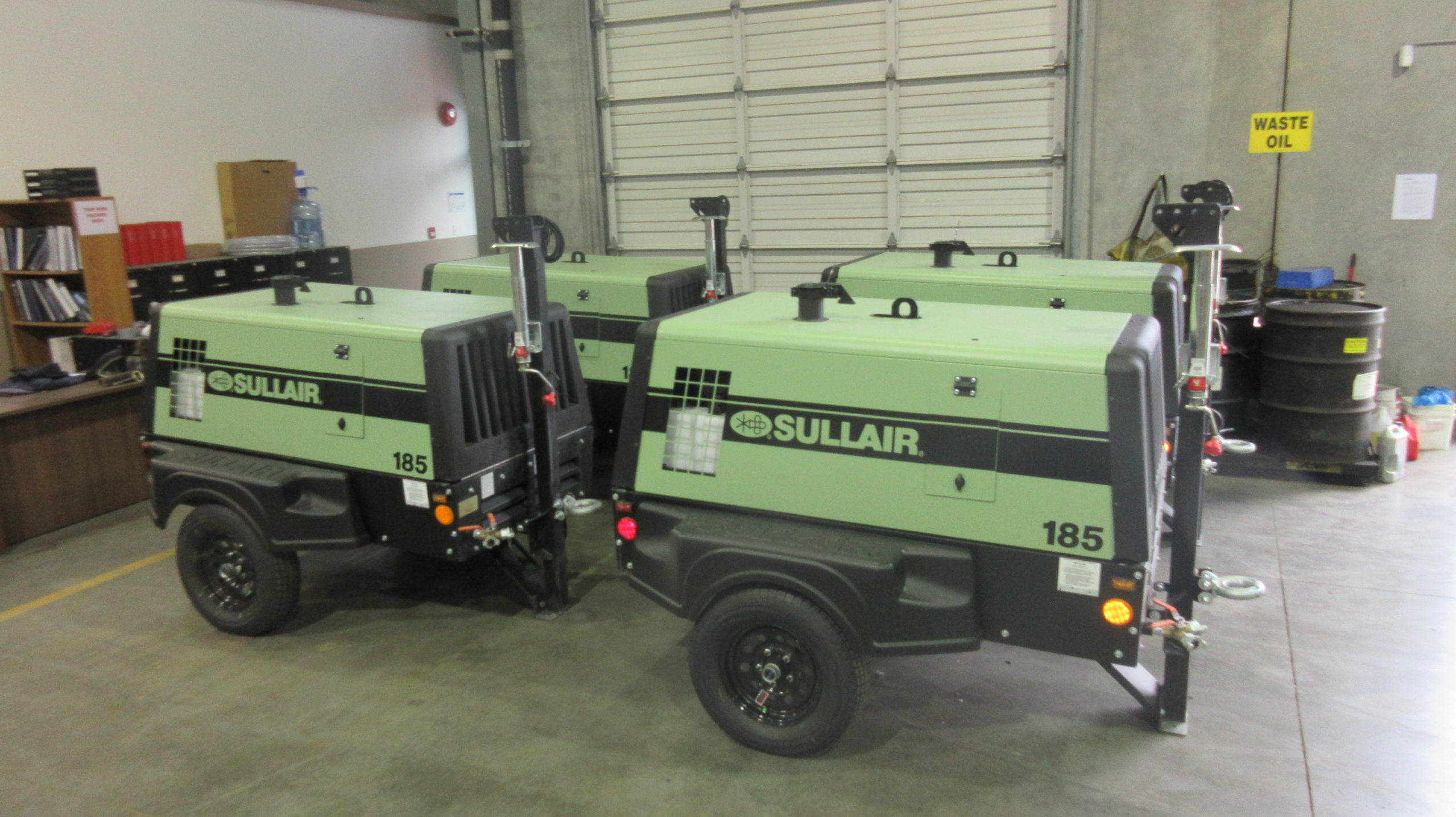 Four Sullair air compressors in warehouse