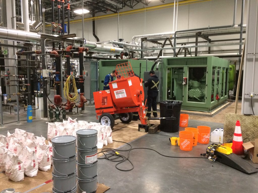 compressor-maintenance maintenance workers fixing shaky air compressor
