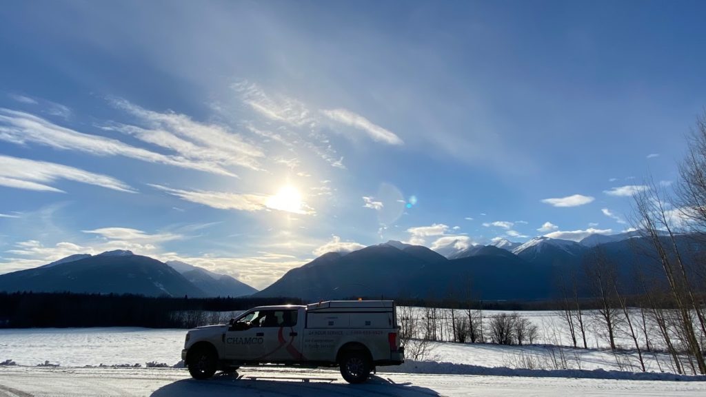 A Chamco truck parked in front of Canadian Rockies