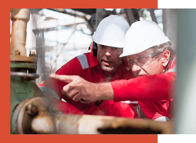 Two men checking parts on pump