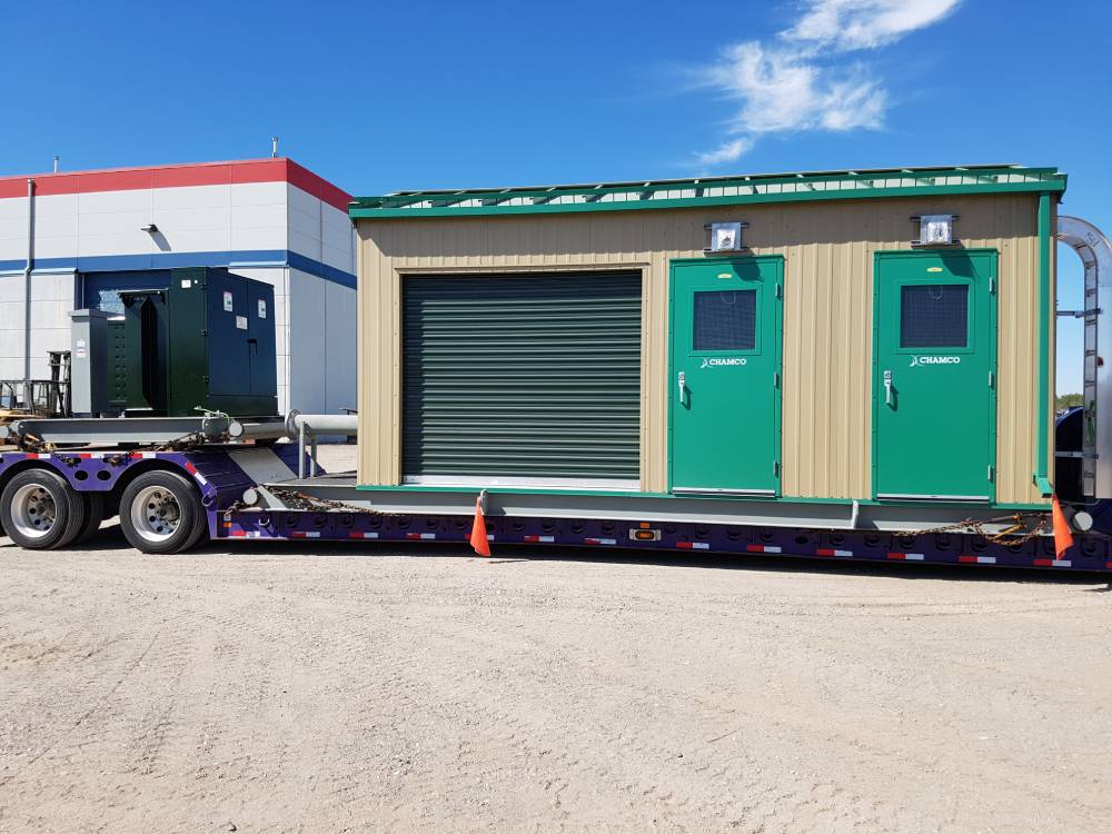 A Chamco pump house on the bed of a trailer.