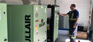 Chamco technician works on air compressors