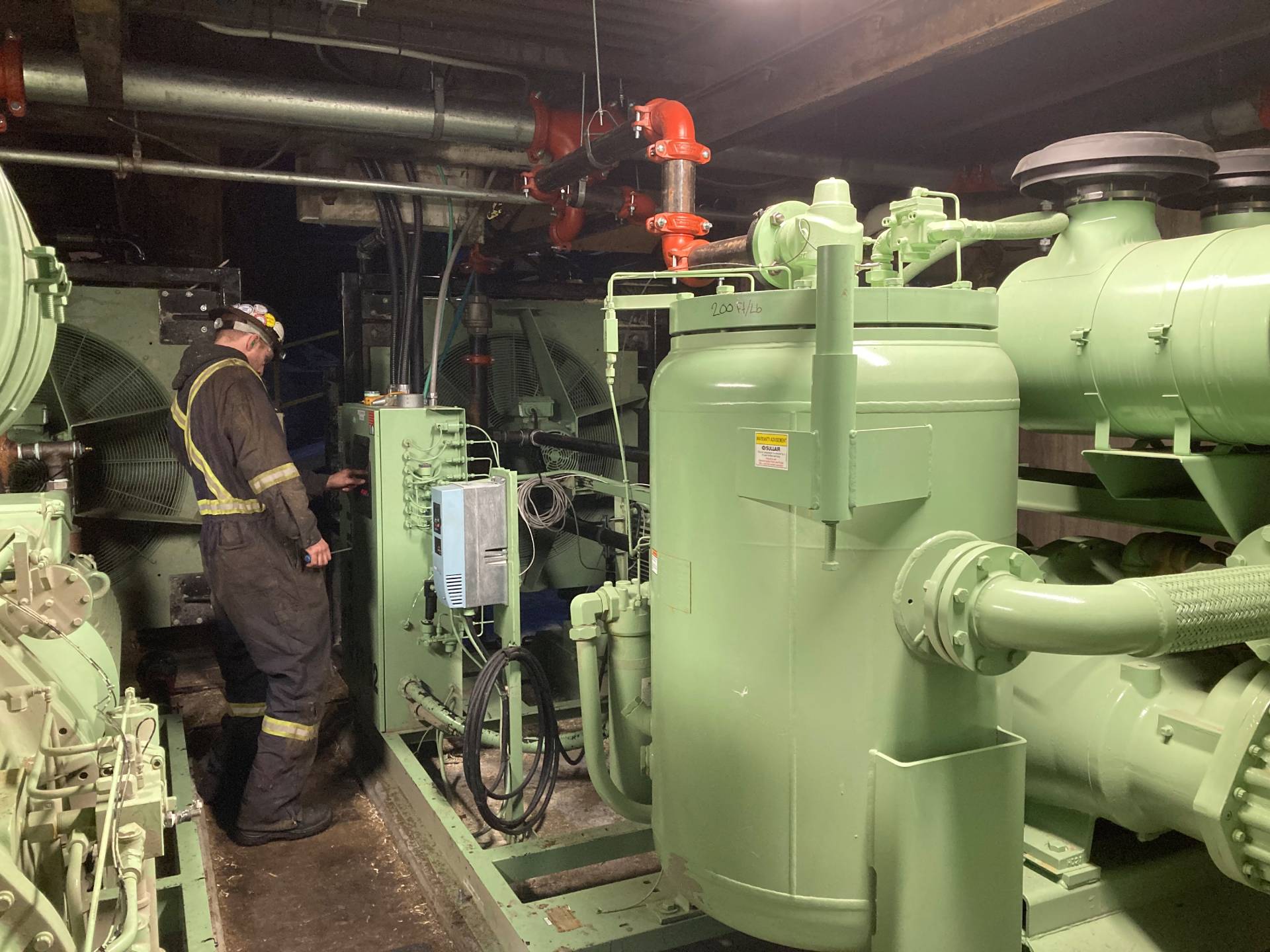 A technician servicing a compressor system