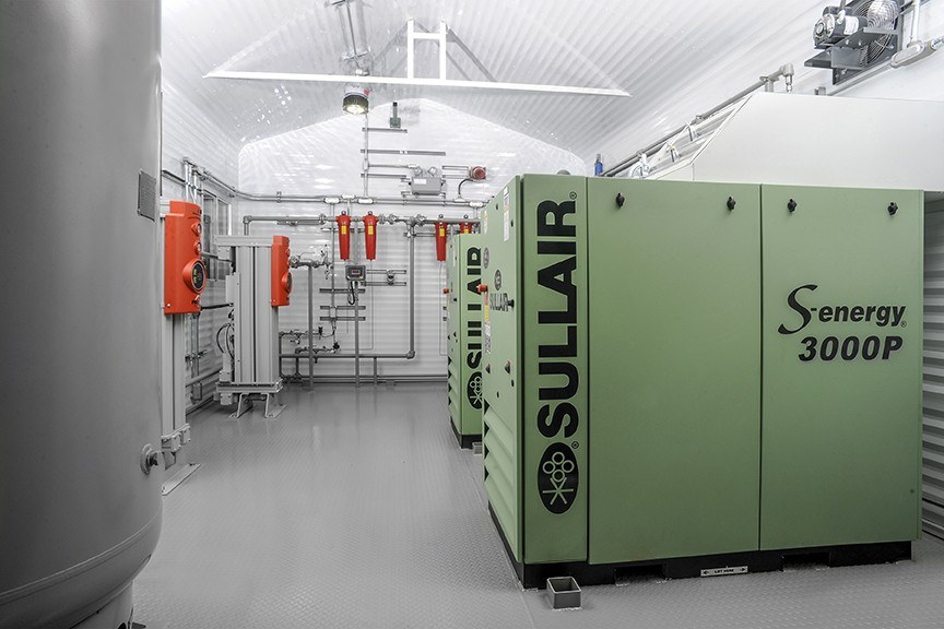 Two green Sullair air compressors