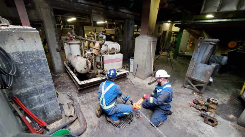 Chamco workers maintaining pump system