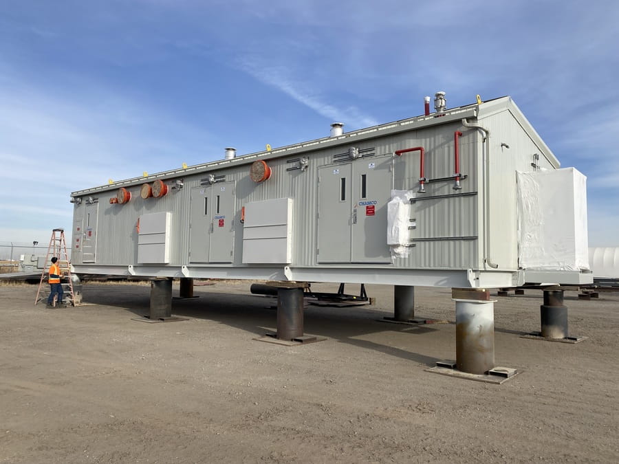 Exterior of a fully assembled Chamco fire pump package elevated on structural pilings, ready for transport from the Calgary facility.