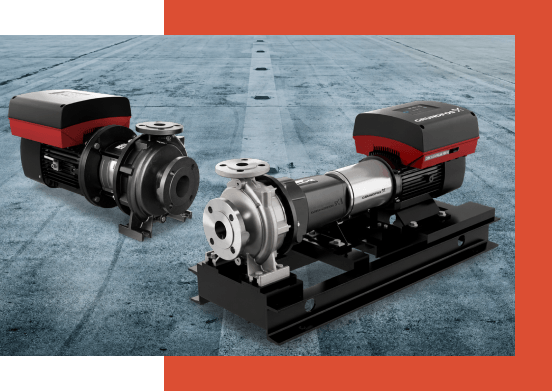 Two industrial pumps with black bases and red tops are placed on a gray, textured surface. The image conveys precision and engineering strength.