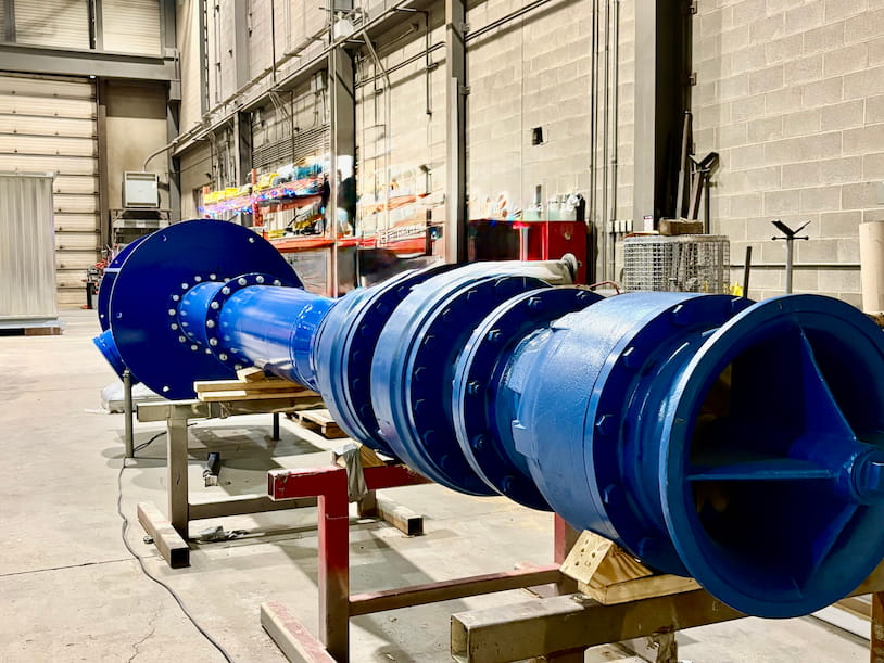 Vertical turbine pump column pipe sections with flanged joints leading to the bowl assembly and impeller, staged in Chamco's fabrication shop